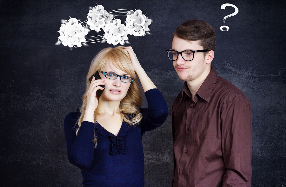 Portrait stressed couple going through hard times in relationship isolated grey background clouds above woman head question mark coming out of confused man. Upset girlfriend bringing bad news on phone